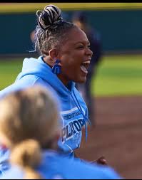 Iyhia McMichael, former Mississippi State All-American and National Pro Fastpitch champion, cheers on her team from the dugout during a game.