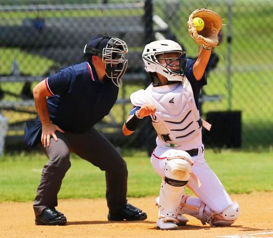 A catcher tracks down a high throw as teams compete during the TC OKC tournament in Oklahoma City.