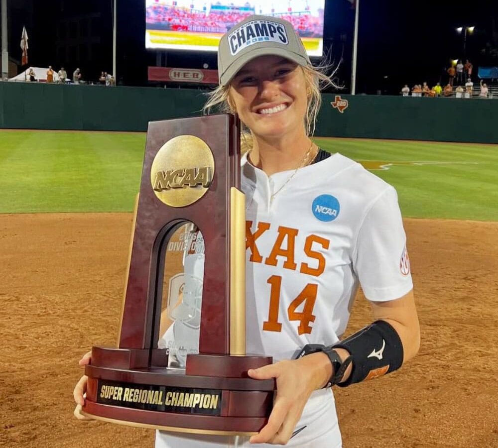 Reese Atwood celebrates Texas’ Super Regional title, holding the NCAA trophy after punching a ticket to the WCWS.