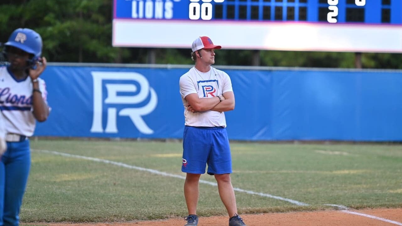 Head Coach Hayden Hollingsworth coaches at 3rd base