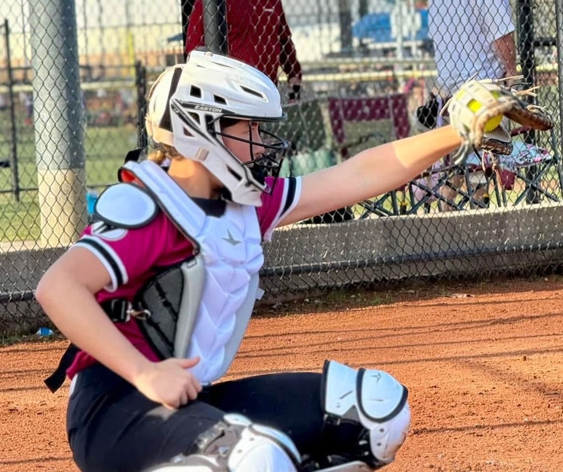 Molly Mayfield frames a pitch behind the plate for a Niceville High School pitcher.