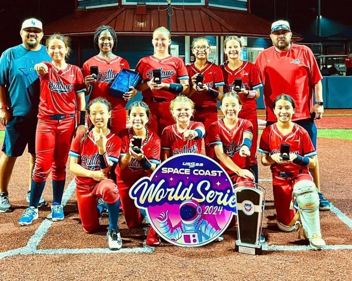  Lady Outlaws 12U celebrate after winning the 2024 USSSA World Series in Florida.