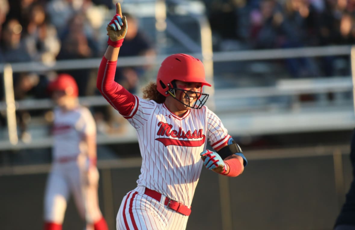 Kennedy Bradley rounds the bases after hitting a home run during a game.