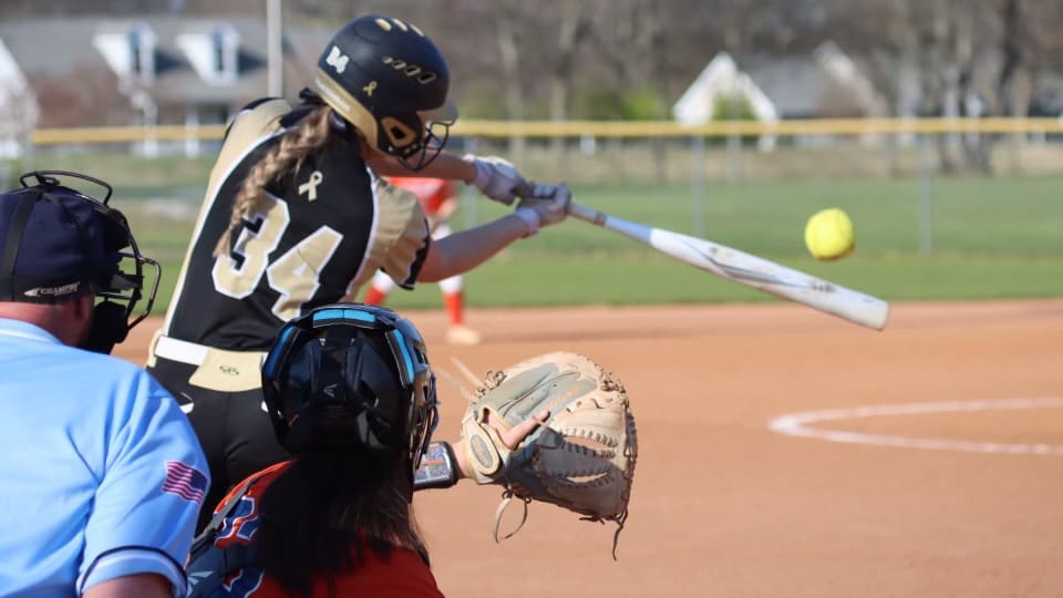 Chloe Younggren makes contact at the plate during game action for her team.